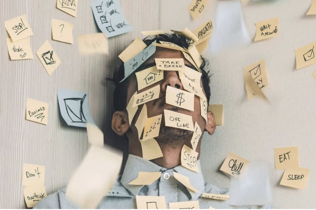 Image of a man covered in post it notes representing the overwhelm of business