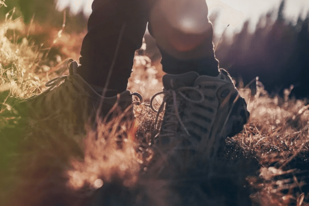 A pair of boots in grass reflecting thinking walking